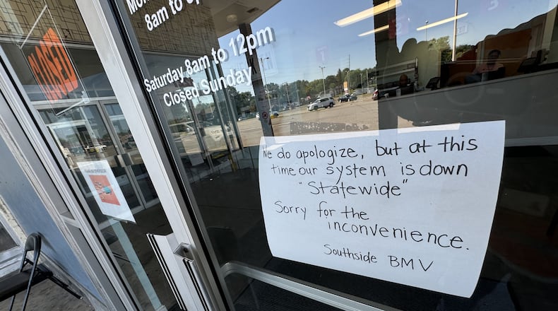 A sign posted to the door at the Ohio BMV site in Springfield Friday morning, July 19, 2024, said the office is closed because its system is down statewide. BILL LACKEY/STAFF