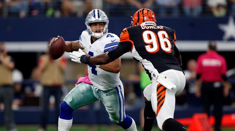 Bengals defensive end Carlos Dunlap draws a bead on Cowboys quarterback Dak Prescott in a game last season at AT&T Stadium in Arlington, Texas.