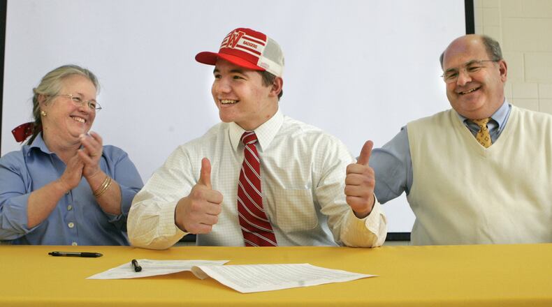 4 Feb 09. Chris Borland gives a thumbs-up after signing his National Letter of Intent to play football at the University of Wisconsin. Celebrating with him are his parents Zebbie (left) and Jeff Borland. The signing took place at Alter High School where Chris is a senior and played on the football team.