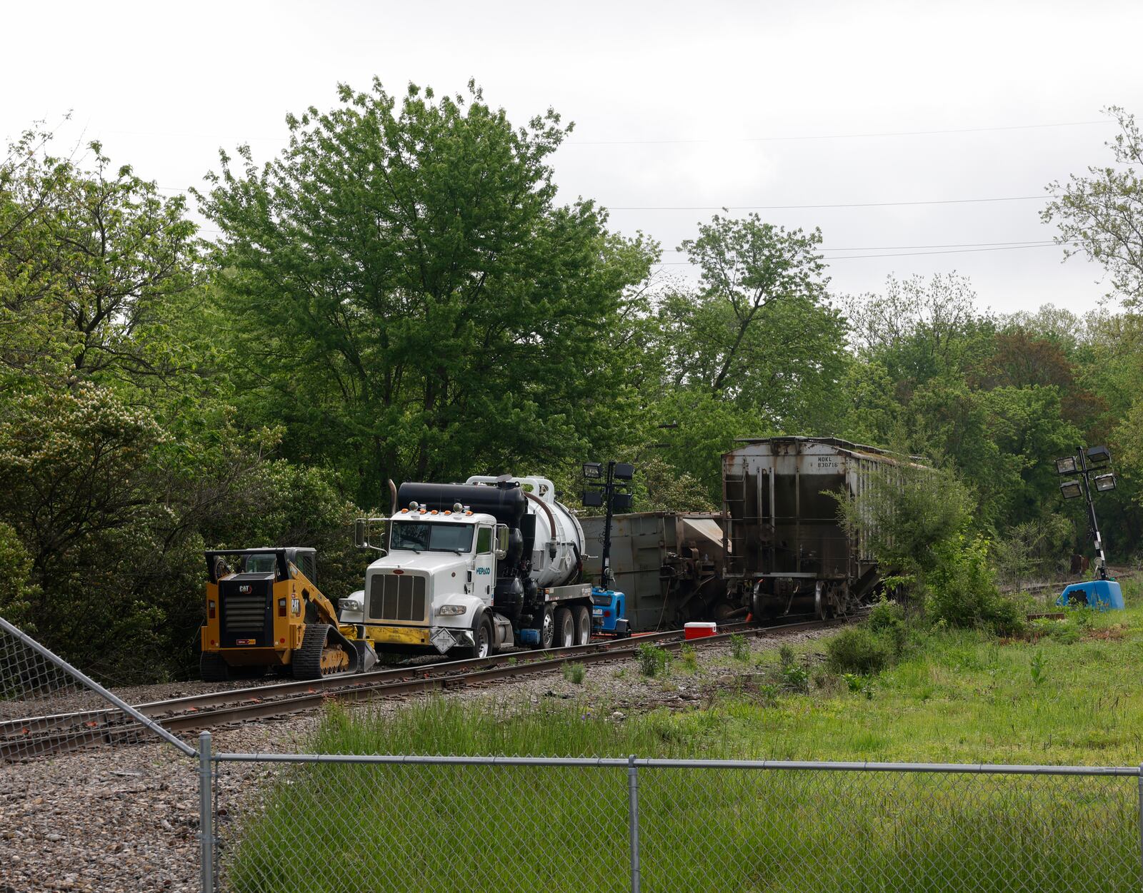 Crews work on a railroad track near Buck Creek on Wednesday, May 14, 2025, as part of continued cleanup following Tuesday's partial train derailment. JOSEPH COOKE/STAFF