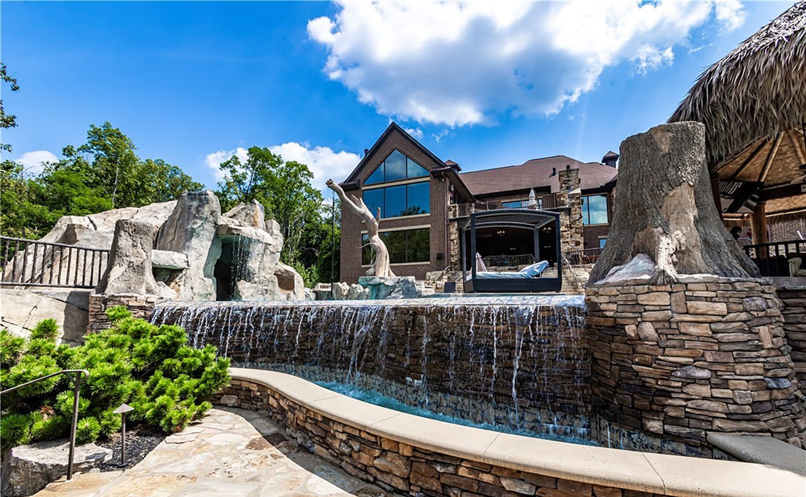 The back yard has rustic features like rough hewn logs, waterfalls and stacked stone walls. CONTRIBUTED