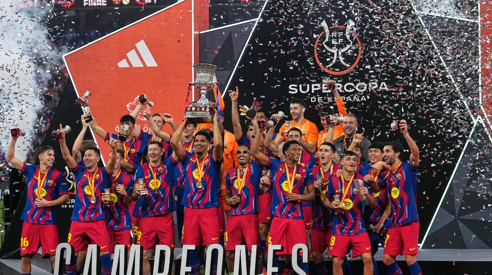 Barcelona players celebrate after winning the Spanish Super Cup final soccer match against Real Madrid at King Abdullah Sports City Stadium in Jeddah, Saudi Arabia, Sunday, Jan. 11, 2026. (AP Photo/Altaf Qadri)