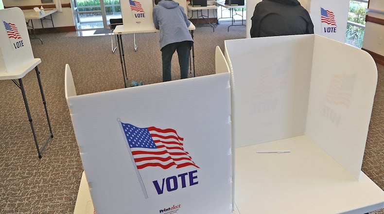 Voters cast their votes at a Springfield Township election poll Tuesday, May 3, 2022. BILL LACKEY/STAFF