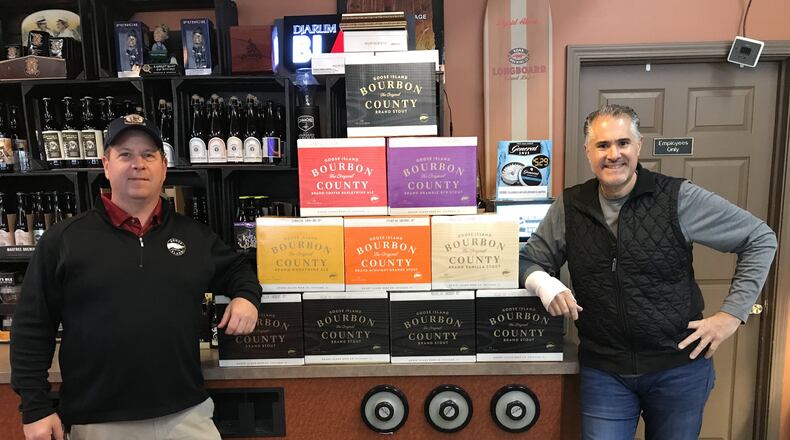George Karras, right, owner of The Market in Kettering, stands with his shipment of Goose Island Bourbon County Brand Stout at his store.
