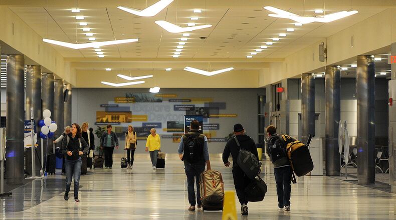 Travelers at the Dayton International Airport. MARSHALL GORBY\STAFF