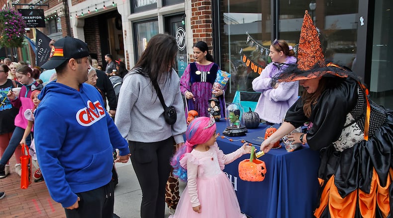 Hundreds of creepy and cute characters filled the sidewalks and streets in downtown Springfield for the sixth annual Downtown Springfield Trick or Treat Friday, Oct. 27, 2023. Downtown merchants, community organizations and nonprofits passed out candy, Halloween characters roamed the streets and danced to music in the streets and magicians were showing off some tricks. BILL LACKEY/STAFF