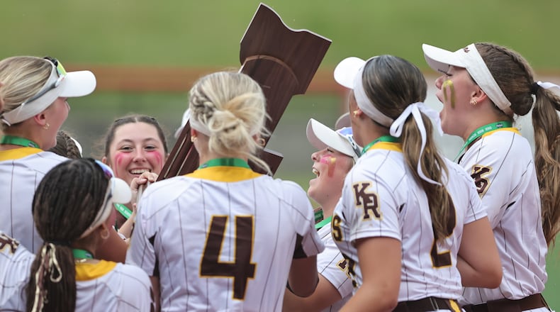 The Kenton Ridge High School softball team hoists the trophy after beating Hillsboro 9-0 in the Division IV state championship game on Thursday, June 5 at Akron's Firestone Stadium. MICHAEL COOPER / STAFF