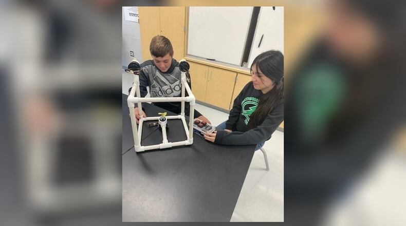 Greenon Junior High School will receive $5,000 to expand STEM learning projects through the Ohio STEM Learning Network Classroom Grant Program, through Battelle. The grant will be used to design a remotely operated vehicle. In this photo is Eli Paulus and Ana Cervantes checking out the prototype and remote of a sample of the project. Contributed