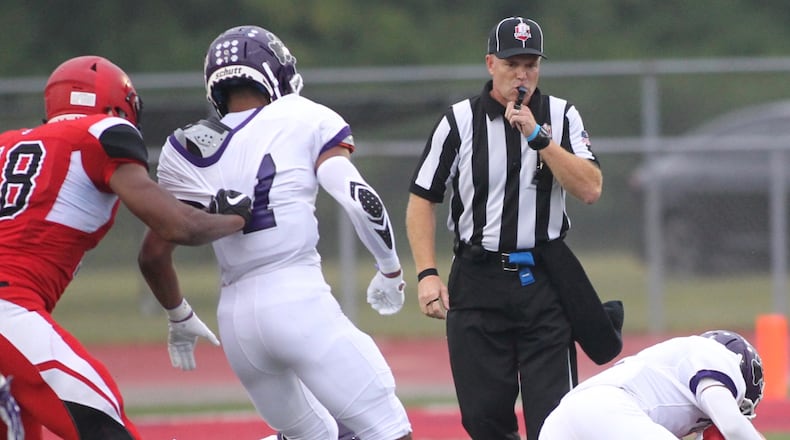 Brian Samborsky, right, officiates a game between Trotwood-Madison and Pickerington Central on Sept. 7, 2018, in Trotwood. David Jablonski/Staff