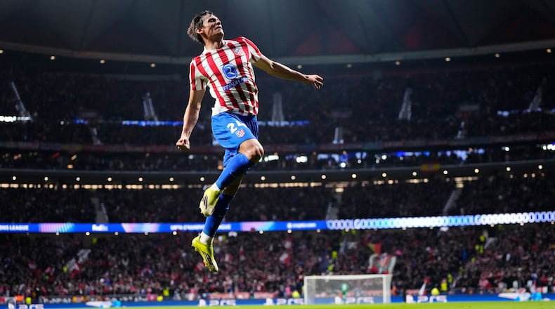 Atletico Madrid's Robin Le Normand celebrates after scoring his side's fourth goal during the first leg of the Champions League round of 16 soccer match between Atletico Madrid and Tottenham in Madrid, Spain, Tuesday, March 10, 2026. (AP Photo/Jose Breton)