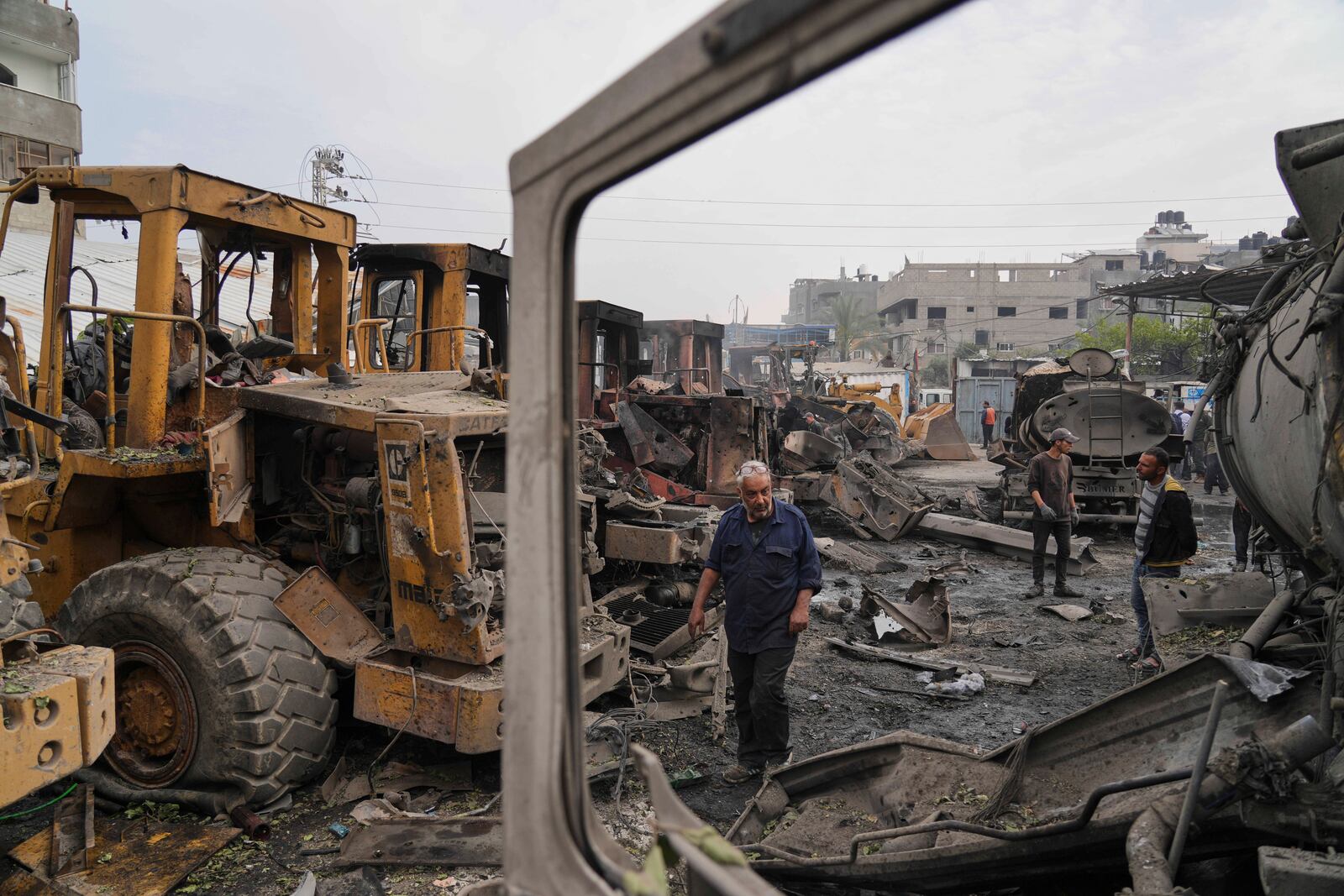 Palestinians examine the remains of bulldozers hit by an Israeli army airstrike in Jabaliya, northern Gaza Strip, on Tuesday, April 22, 2025. (AP Photo/Jehad Alshrafi)