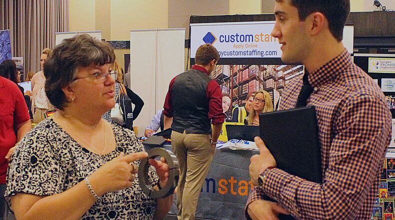 Jeannie Seery with Rose City Manufacturing explains to Dominic Finch what her employer makes has to offer to new hires. JEFF GUERINI/STAFF