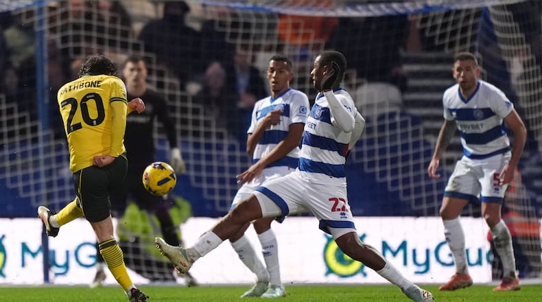 Wrexham's Ollie Rathbone, left, scores their side's third goal of the game during the Sky Bet Championship soccer match between Queens Park Rangers and Wrexham in London, Saturday Jan. 24, 2026. (Ben Whitley/PA via AP)