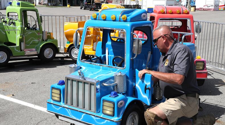 A state inspector goes over the “Mighty Mac” ride at the Clark County Fair Thursday. The inspectors spent the day checking all the rides for safety concerns. BILL LACKEY/STAFF