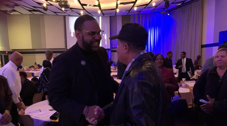 Guest speaker Dr. Maurice Stinnett greets an attendee of the Springfield unit of the NAACP s 5th Annual Freedom Fund Banquet at the Hollenbeck Bayley Creative Arts and Conference Center on Friday. BRETT TURNER / CONTRIBUTED