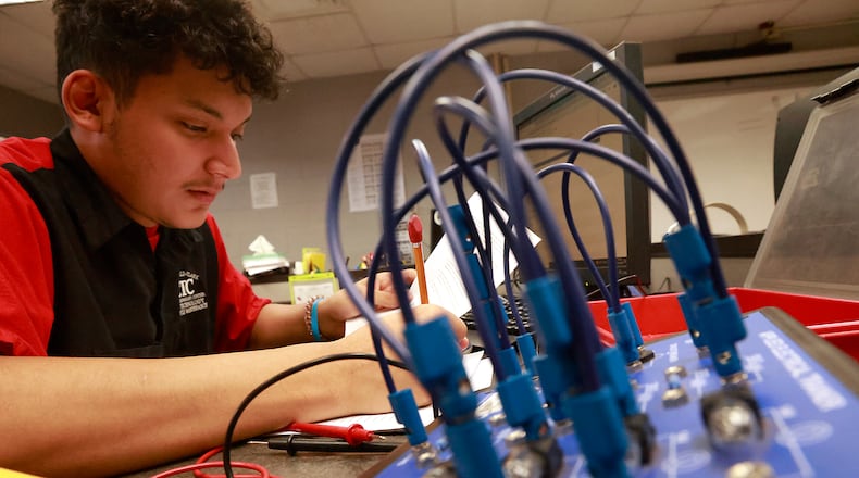 Steven Lopez Ramirez, a senior at Springfield High School, works in his Automotive Technology & Motorcycle Maintenance program at the Springfield-Clark CTC on Friday, Oct. 18, 2024. BILL LACKEY/STAFF