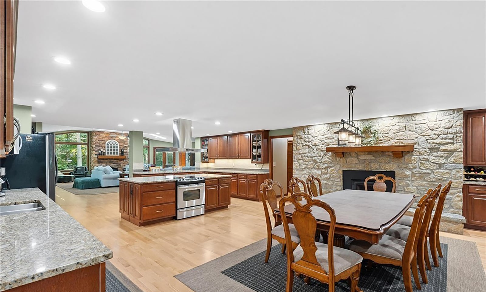 The open concept kitchen and great room has hardwood floors, two woodburning fireplaces and vaulted ceilings. CONTRIBUTED