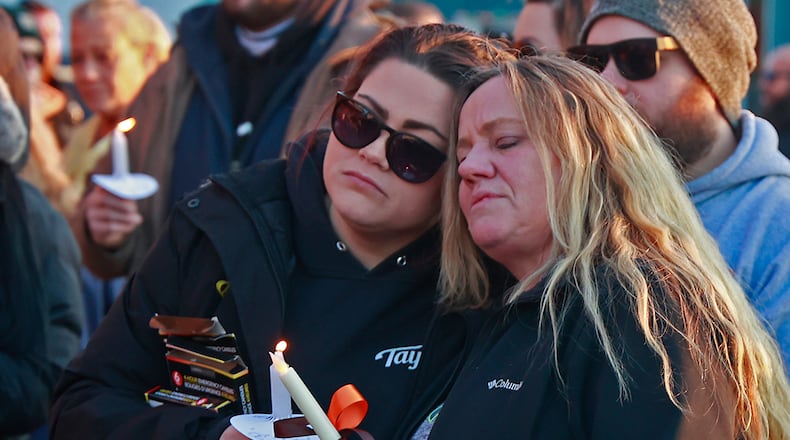 Family, friends and community members fill the parking lot of Gill's Quality Meat Market Monday, Jan. 9, 2023 during a candle light vigil for Thomas Gill, who was shot and killed last Thursday while driving his SUV in Springfield.