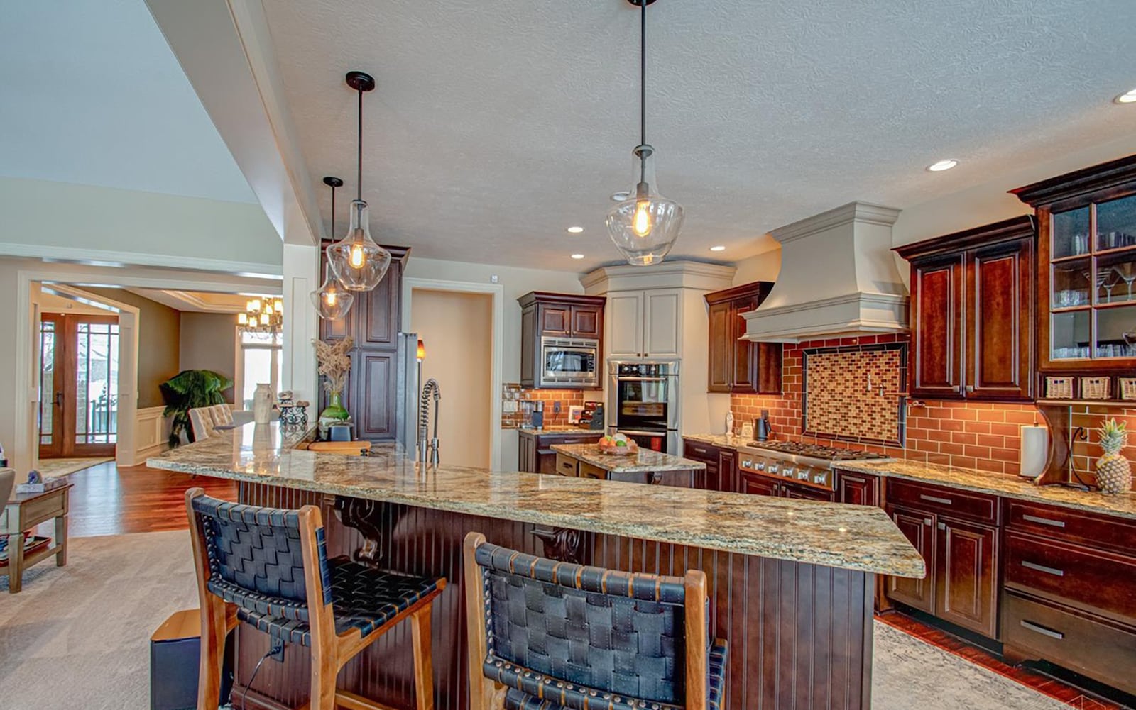 The kitchen has been updated with gourmet style appliances. It has hardwood flooring, an attached breakfast nook and a breakfast bar as well as granite countertops and a tile backsplash. CONTRIBUTED