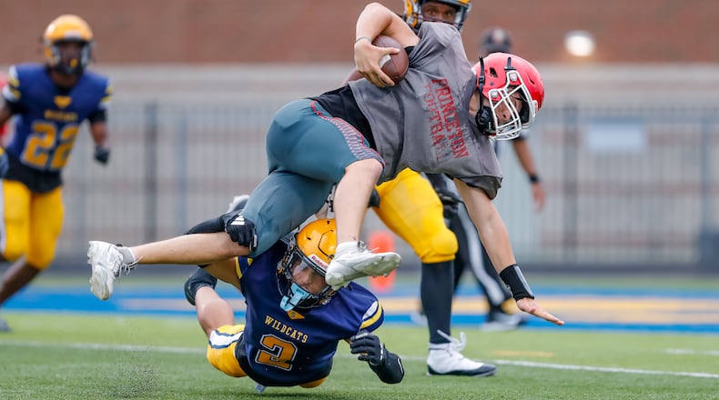 Springfield High School senior safety Quenta "Bop" Wafer tackles Princeton junior quarterback Deangelo Birch during a scrimmage on Thursday night in Springfield. Michael Cooper/CONTRIBUTED