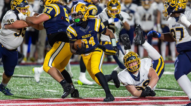 Springfield's Deontre Long looks for room to run vs. Moeller in the state semifinals at Piqua on Nov. 24, 2023.. Michael Cooper/CONTRIBUTED