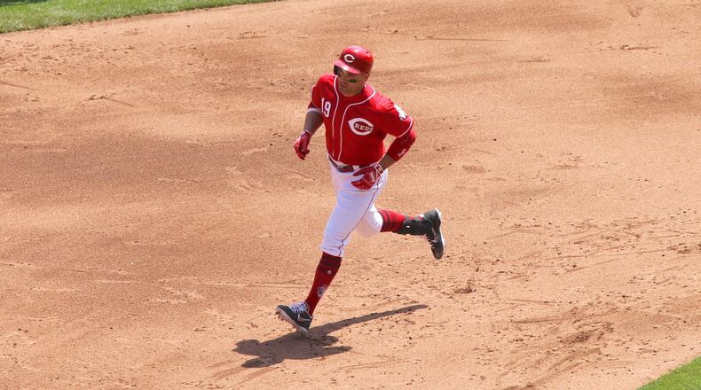 The Reds’ Joey Votto rounds the bases after a three-run home run against the Braves on Thursday, April 26, 2018, at Great American Ball Park in Cincinnati. David Jablonski/Staff