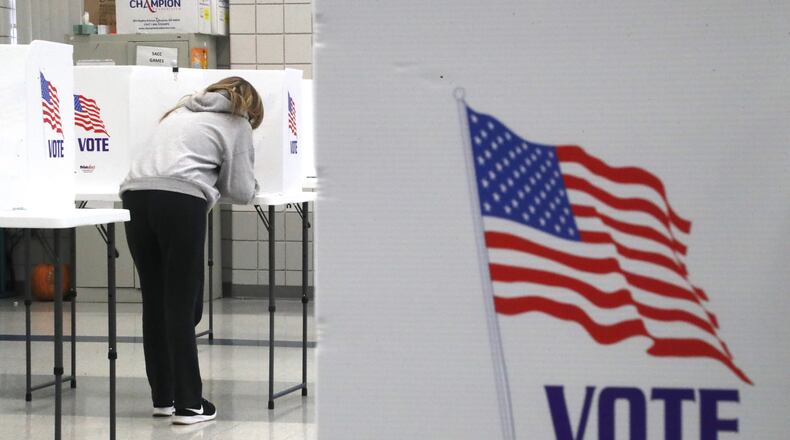 A woman casts her ballot in the Nov. 3, 2020, general election at Fulton Elementary in Springfield. Residents in cities and townships across Clark County will vote on a variety of topics come election day in May. BILL LACKEY/STAFF