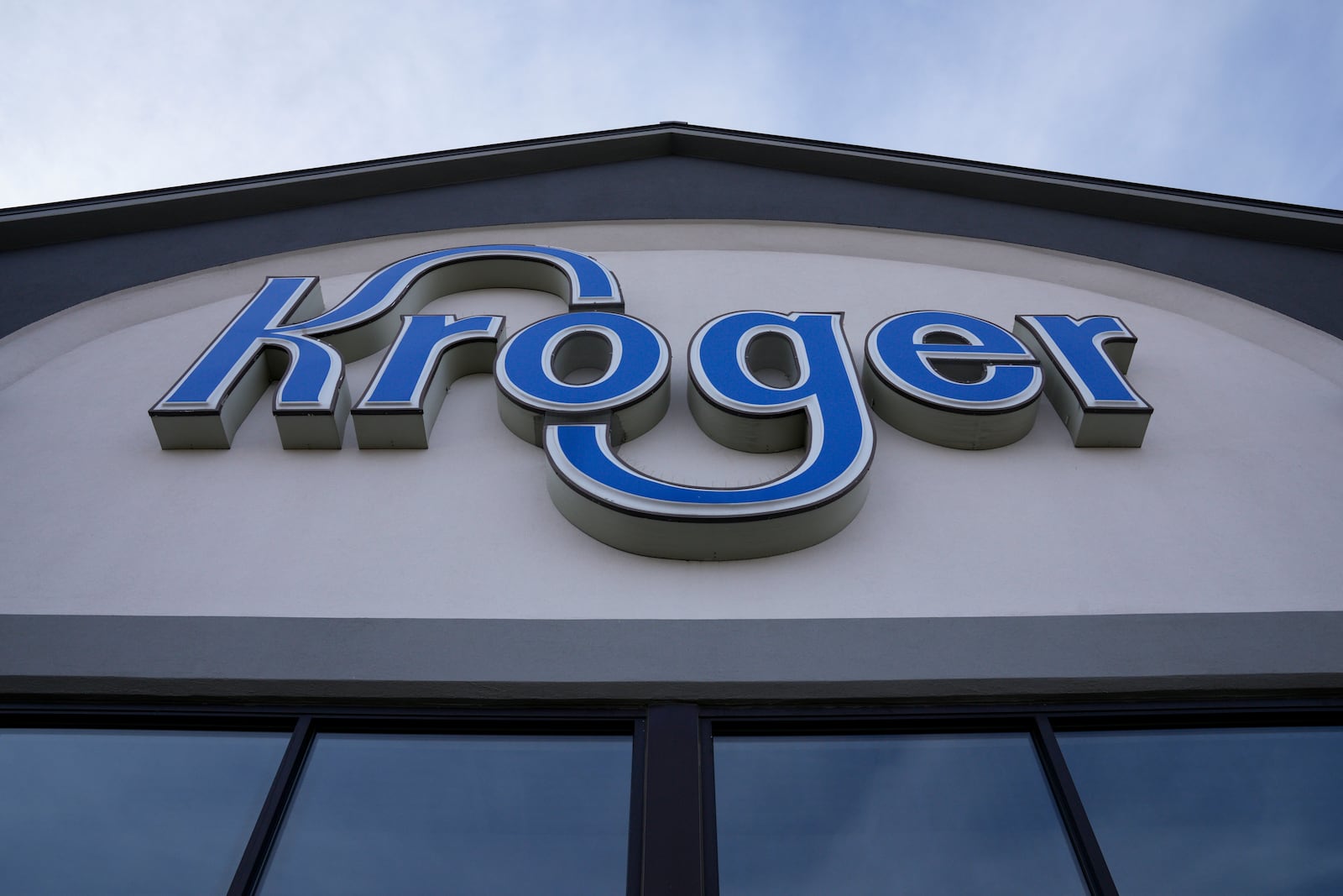 FILE - A sign is affixed to the exterior of a Kroger grocery store in Monroe, Ohio, in this undated photo. (AP Photo/Jeff Dean, File)