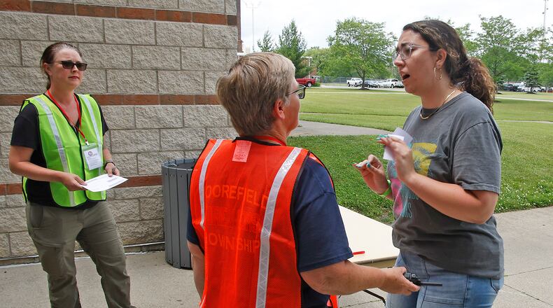 A woman, playing the part of an upset parent, argues with staff as she tries to get her child at Springfield High School during a reunification training session Wednesday, June 5, 2024. Most of the Clark County schools along with law enforcement and fire personel participated in the two day training to learn how to get students back with their parents after an emergency situation. BILL LACKEY/STAFF