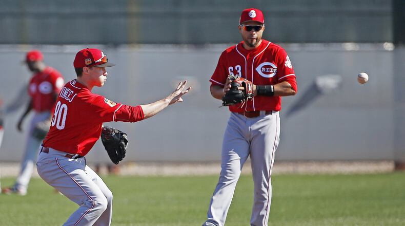Cincinnati Reds infielder Zach Vincej flips the ball to second base as Hernan Iribarren looks on. Vincej, a former Dayton Dragon, is in the mix for a utility role. AP photo