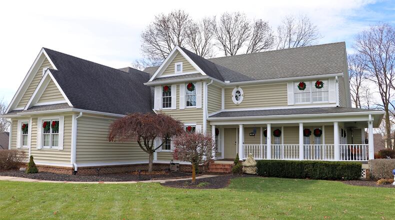 A wrap-around covered porch offers a warm invitation into a Miamisburg home. Contributed photos by Kathy Tyler