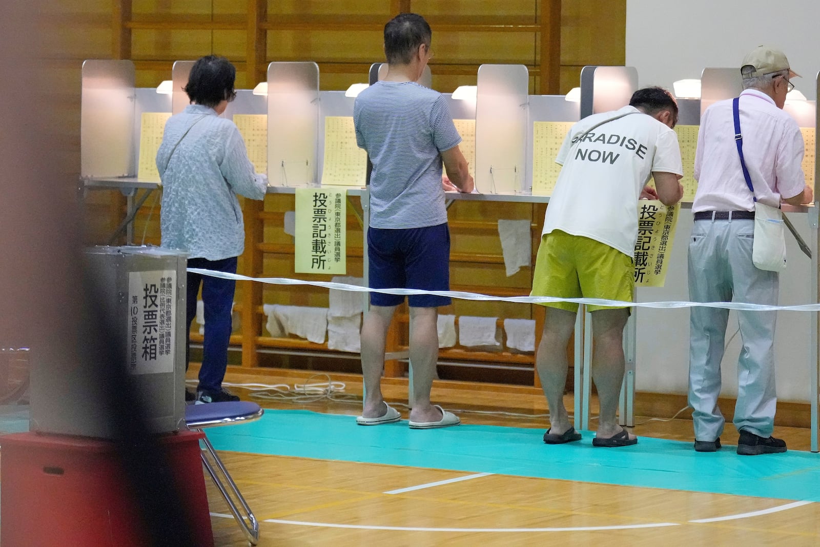 Voters fill in their ballots in the upper house election at a polling station Sunday, July 20, 2025, in Tokyo. (AP Photo/Eugene Hoshiko)