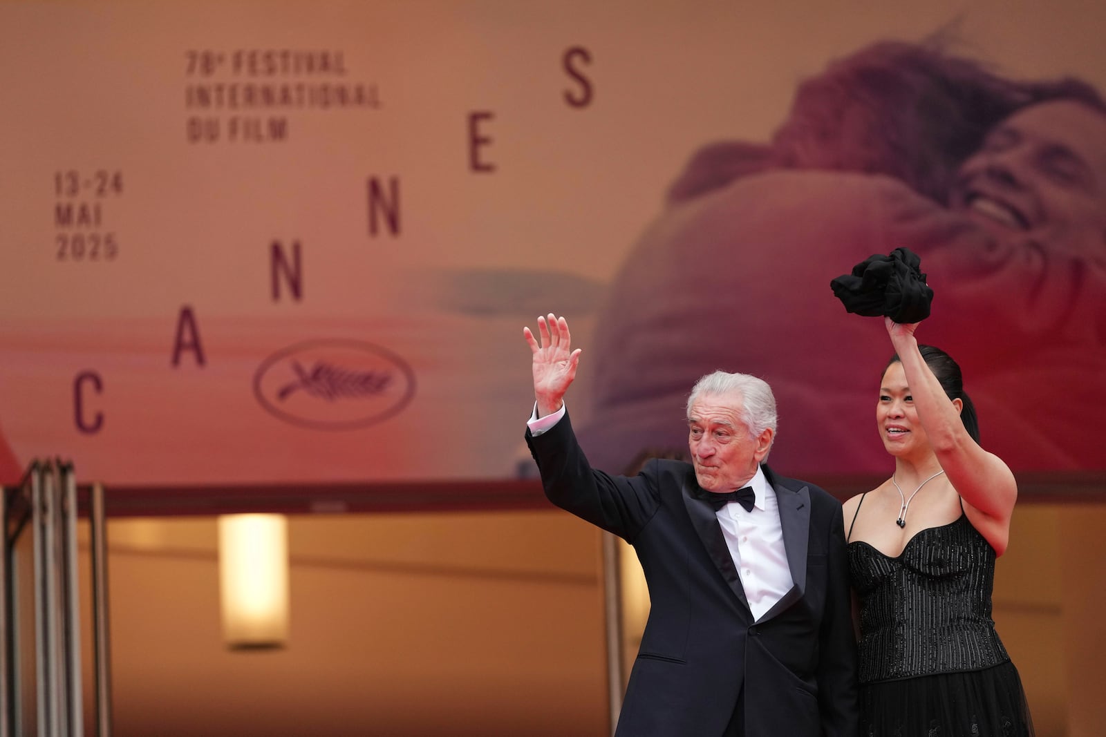 Robert De Niro, left, and Tiffany Chen pose for photographers during the opening ceremony red carpet of the 78th international film festival, Cannes, southern France, Tuesday, May 13, 2025. (Photo by Scott A Garfitt/Invision/AP)