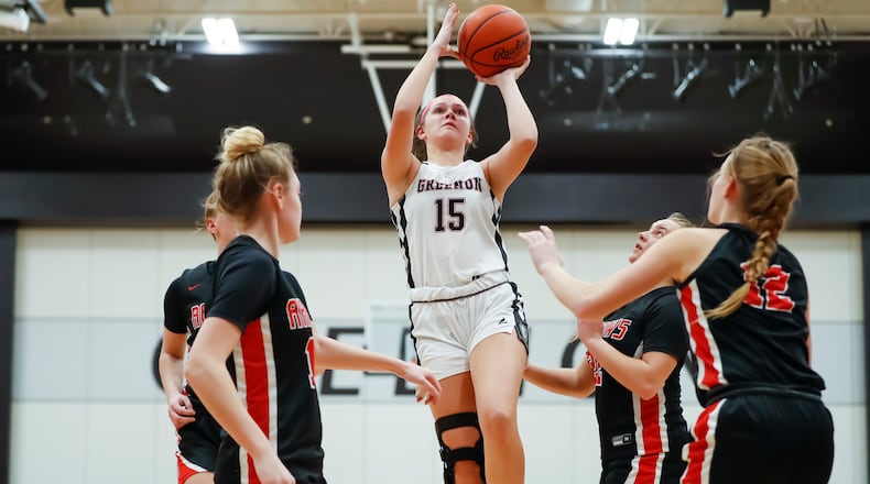 Greenon High School senior Abby West shoots a jumper over several defenders during their game against Tecumseh earlier this season. West recently surpassed 1,000 career points. Michael Cooper/CONTRIBUTED