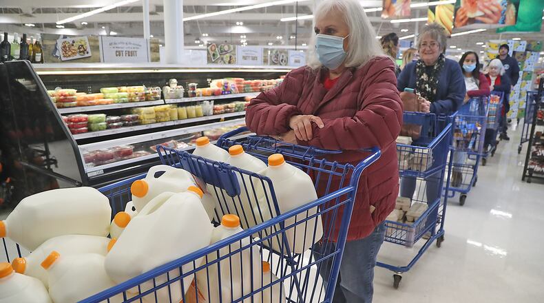 Operation Thanksgiving volunteers line up at Meijer to check out Tuesday with enough food for 25 families to have Thanksgiving dinner. This is the 30th year the Springfield Police Division has helped needy families at Thanksgiving. BILL LACKEY/STAFF