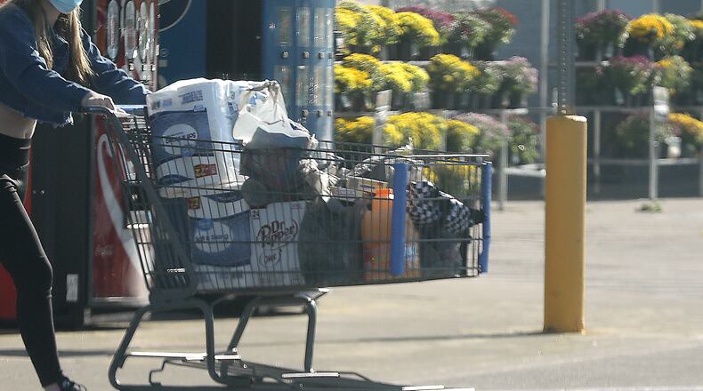 A shopper leaves a local store Thursday. BILL LACKEY/STAFF