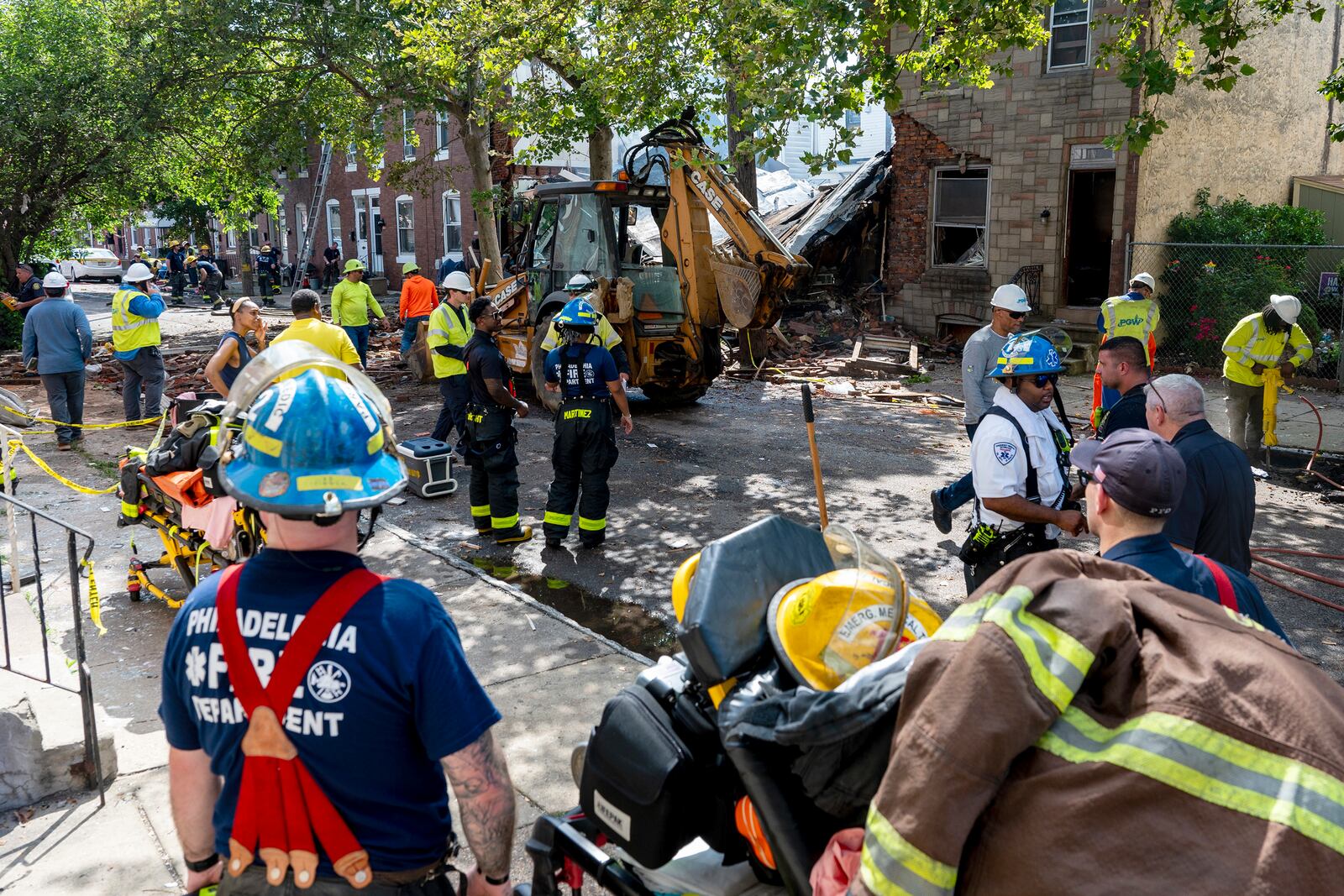 Officials work the scene in the Nicetown area of Philadelphia, Sunday, Jun. 29, 2025, where there were fatalities after three row houses collapsed after a fire and explosion. (Tom Gralish/The Philadelphia Inquirer via AP)