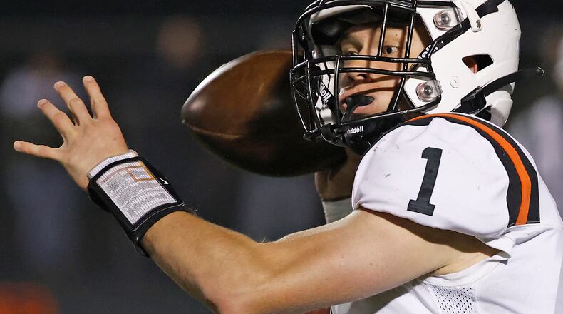 Waynesville's Alex Amburgy throws a pass during Friday's playoff game against Valley View.. BILL LACKEY/STAFF