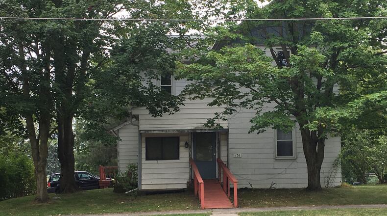 Investigators say the boy was pinned between a pickup truck and a lawnmower at this home in the 100 block of S. Sandusky Street in Rushsylvania. STAFF PHOTO/Collins