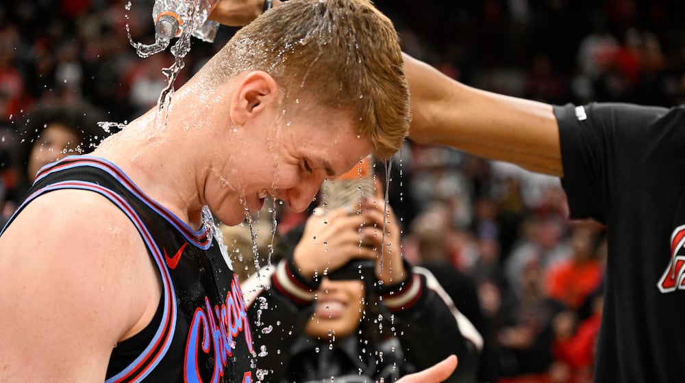 Chicago Bulls guard Kevin Huerter gets doused with water after an NBA basketball game against the Boston Celtics, Saturday, Jan. 24, 2026, in Chicago. Huerter scored the game winning three-point basket. (AP Photo/Matt Marton)