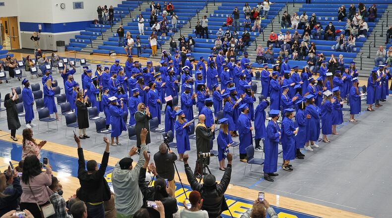 Family and friends cheer as the Springfield High School class of 2021 is presented at the conclusion of the first of three graduation ceremonies Saturday. BILL LACKEY/STAFF