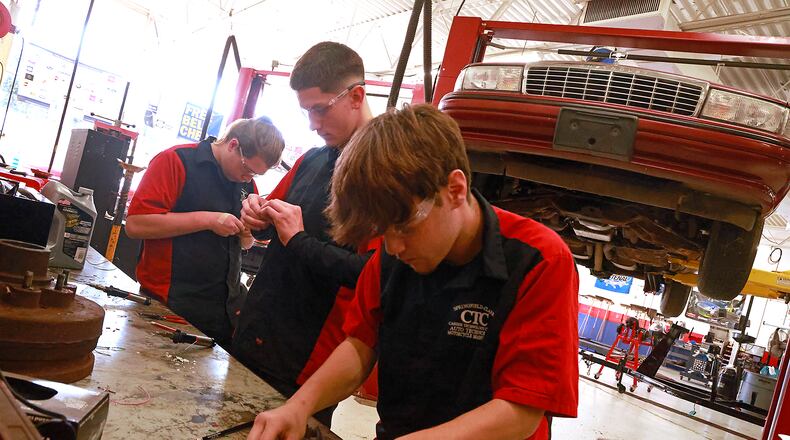 Springfield-Clark CTC students in the Automotive Technology & Motorcycle Maintenance program work on their soldering skills Friday, Oct. 18, 2024. Pictured are Korey Kolowena, senior, Tecumseh High School; Greg Lange, senior, Shawnee High School; and Caleb Weese, senior, Greenon High School. BILL LACKEY/STAFF