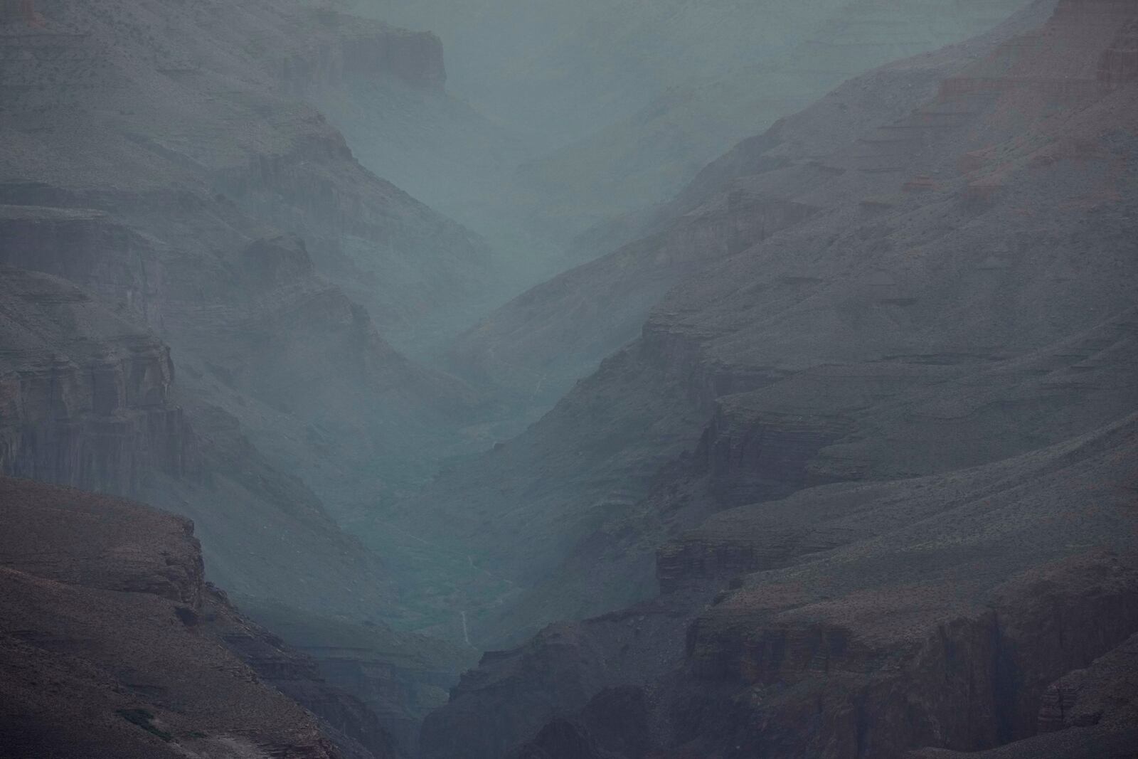 Smoke from the Dragon Bravo Fire moves down the Grand Canyon from the North Rim Tuesday, July 15, 2025, in Grand Canyon National Park, Ariz. (AP Photo/Ross D. Franklin)