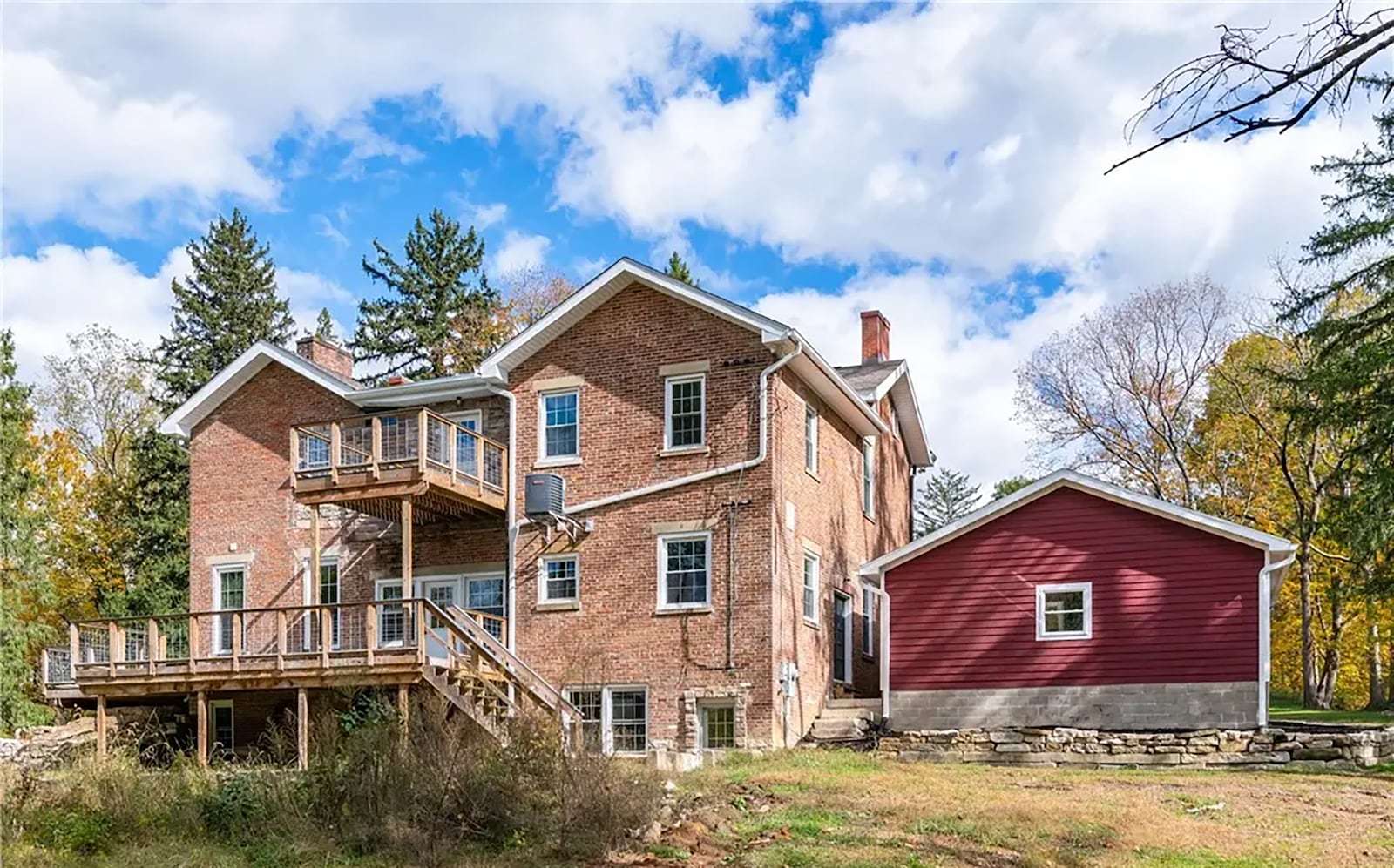 The back of the home has a wrap around composite deck with railings that goes to the side of the house and an upper level balcony off one bedroom. CONTRIBUTED