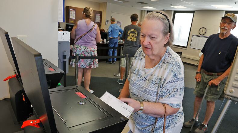 Dolores Simons slides her ballot in the voting machine as she votes early at the Clark County Board of Elections Friday, August 4, 2023. BILL LACKEY/STAFF