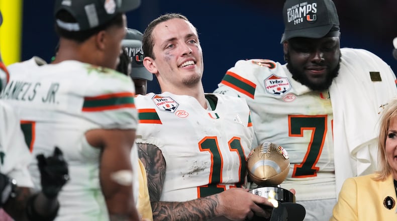 Miami quarterback Carson Beck (11) holds the offensive player of the game trophy after winning the Fiesta Bowl NCAA college football playoff semifinal game against Mississippi, Thursday, Jan. 8, 2026, in Glendale, Ariz. (AP Photo/Ross D. Franklin)