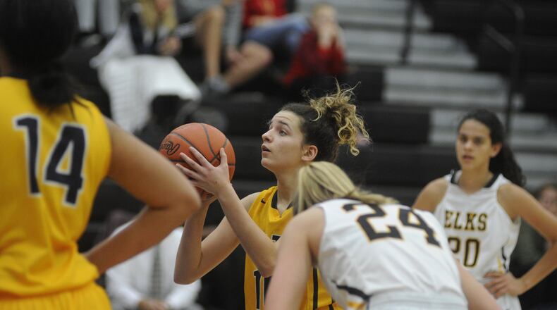 Mickayla Perdue of Springfield High School (shooting) will graduate early and sign with the University of Toledo to play basketball. MARC PENDLETON / STAFF