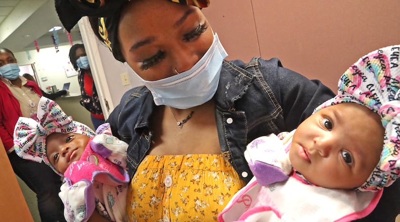 Kimbia Ingram, from Springfield, with her 4-month-old twins Friday, May 20, 2022. Kimbia says she goes through a can of formula every day and says she has to drive to five different stores to find the one can. BILL LACKEY/STAFF