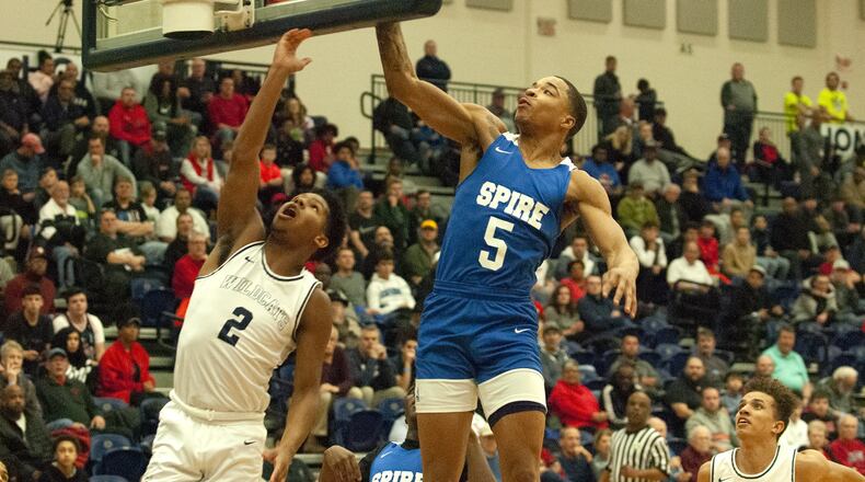 Spire Academy’s RaHeim Moss blocks a shot by former teammate Jalan Minney during Monday’s game at Flyin’ To The Hoop. Spire won 78-42 and Moss scored nine points. Jeff Gilbert/CONTRIBUTED