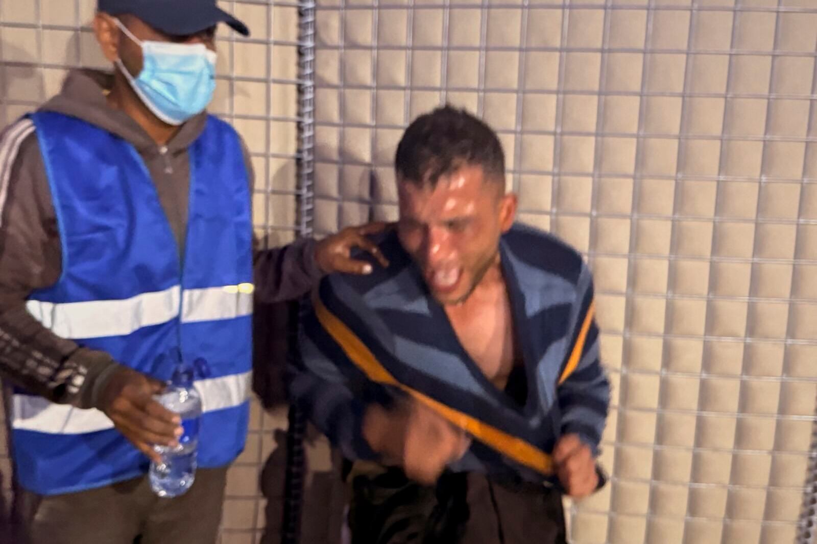 This photo, provided by an American contractor on condition of anonymity, shows a man reacting after being tear gassed at a distribution site run by the Gaza Humanitarian Foundation in Gaza in June 2025. (AP Photo)